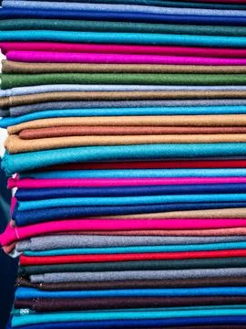Stack of colorful Andean wool fabrics at Otavalo Market Ecuador Stock Photos