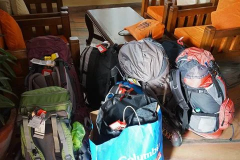 Stack of colorful backpacks and stuff on the ground Stock Photos