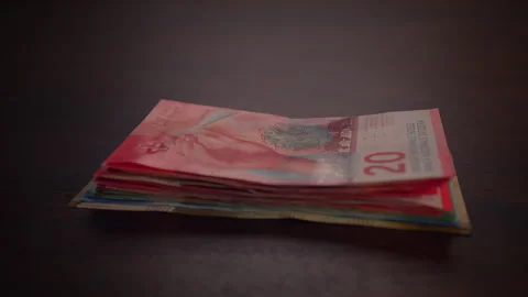 A Stack of Colorful Banknotes Arranged Neatly on a Dark Surface for Visual Stock Footage 294782788
