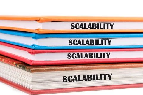 A stack of colorful binders labeled scalability sits on a desk, emphasizing i 스톡 사진