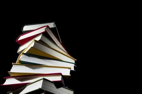 Stack of colorful books on a black background Stock Photos