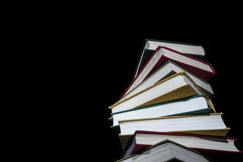 Stack of colorful books on a black background Stock Photos