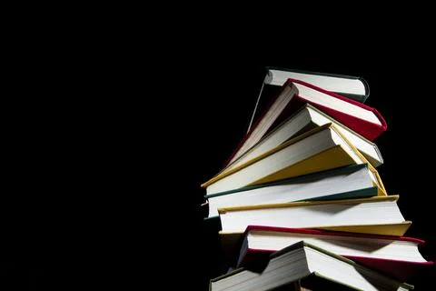 Stack of colorful books on a black background Foto stock