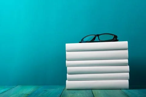 Stack of colorful books, grungy blue background, free copy space Stock Photos