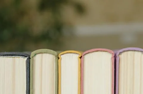 A stack of colorful books in a library Stock Photos