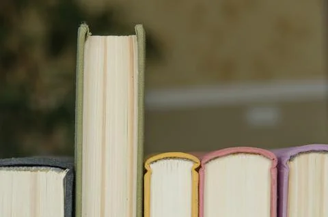 A stack of colorful books in a library Stock Photos