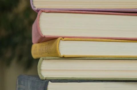 A stack of colorful books in a library Stock Photos