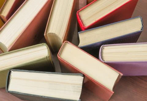 A stack of colorful books in a library Stock Photos