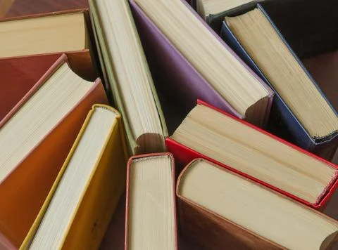 A stack of colorful books in a library Stock Photos