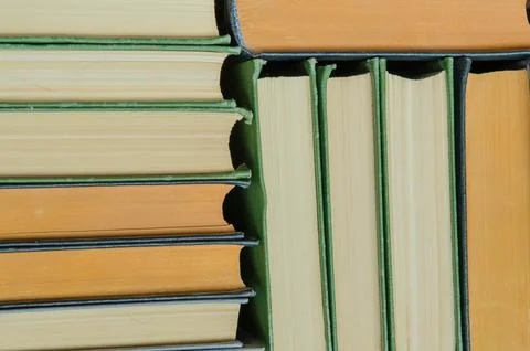 A stack of colorful books in a library Stock Photos