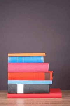 Stack of colorful books on the shelf. Stock Photos