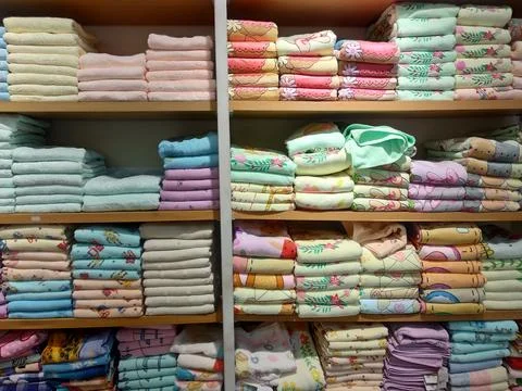 Stack of colorful character towels on a shelf Stock Photos
