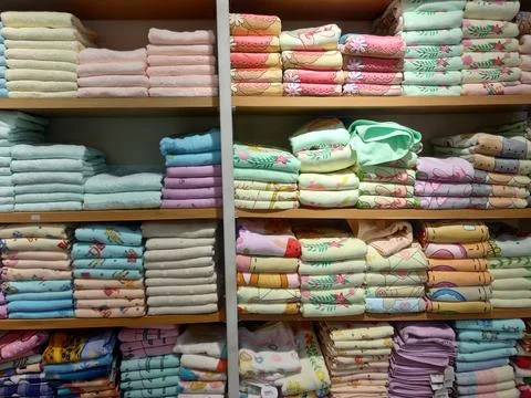 Stack of colorful character towels on a shelf Stock Photos