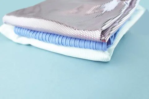 Stack of Colorful clothes isolated on blue background. 库存照片