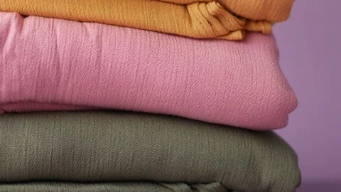 Stack of colorful cloths on table. Video stock 196985039