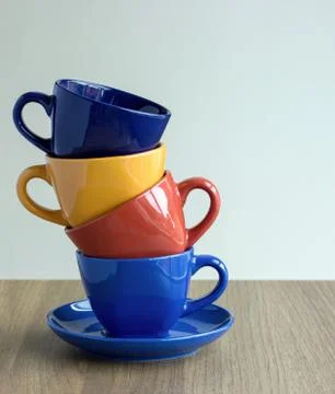 Stack of colorful coffee cups on table Stock Photos