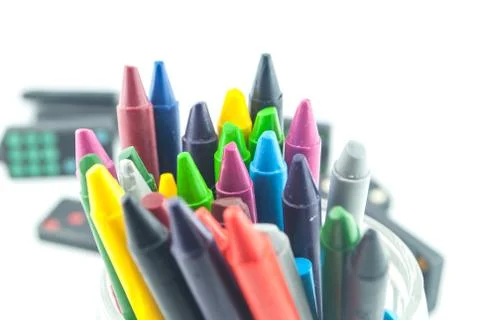 A stack of colorful crayons on an isolated white background. Stock Photos