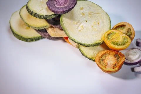 A stack of colorful dried vegetable slices, including zucchini, purple potatoes. Stock Photos