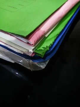 Stack of colorful file folders with papers on black background Stock Photos