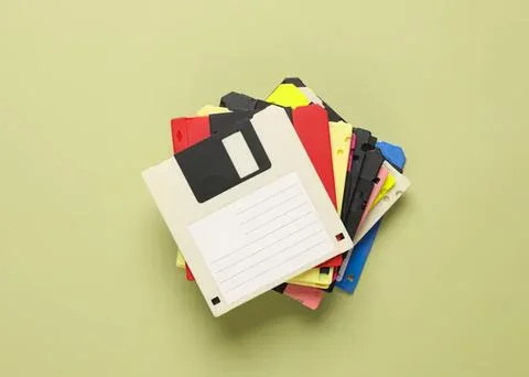 Stack of colorful floppy disks on light green background Stock Photos