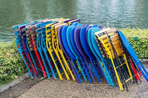 Stack of colorful folding tables and chairs by the water in Bergen, Norway Stock Photos