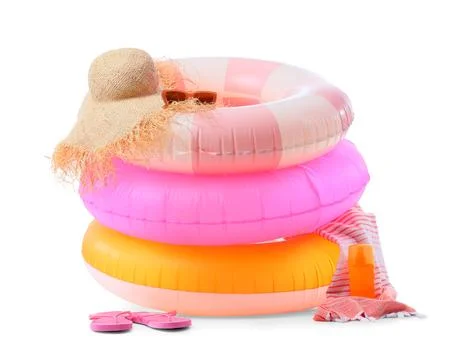 Stack of colorful inflatable swimming rings with a straw hat, sunglasses, fli Stock Photos