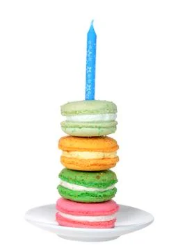 Stack of colorful macaron cookie with cream filling on a white plate with blu Stock Photos