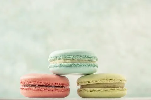 Stack of colorful macaroons over green with copy space Fotos Stock