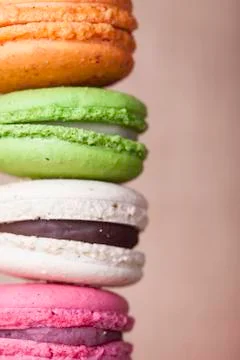 Stack of colorful macaroons vintage textile background closeup Stock Photos
