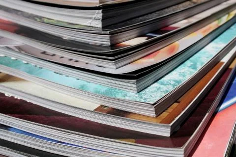 Stack of colorful magazines close up Stock Photos