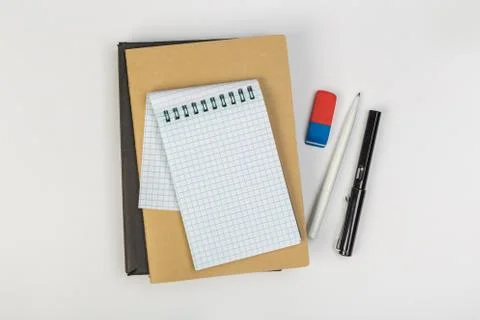 Stack of colorful notebooks with pen isolated on white background Stock Photos