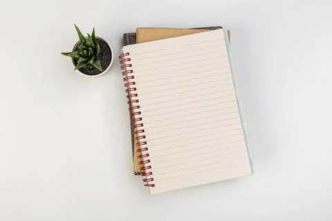 Stack of colorful notebooks with pen isolated on white background Stock Photos