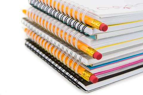Stack of colorful notebooks with pencils isolated on white Stock Photos
