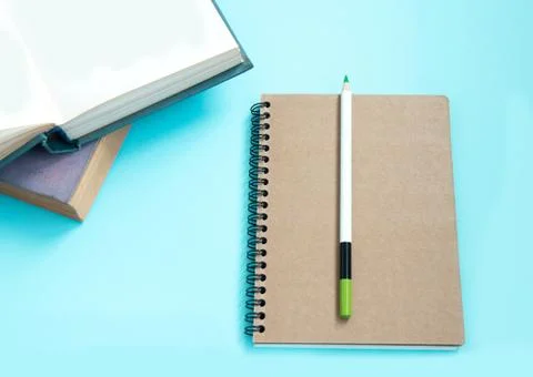 Stack of colorful old hardback books with brown notebook and pencil. Many Boo Stock Photos