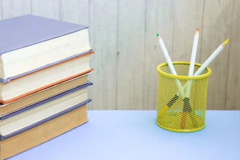 Stack of colorful old hardback books glass with pencils. Hardback books Stock Photos