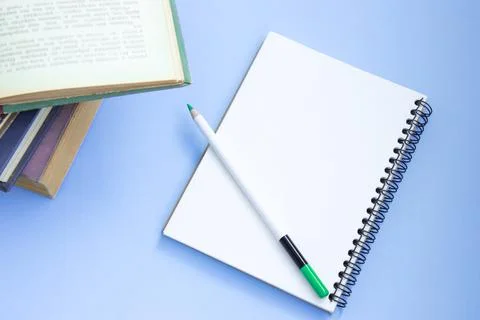 Stack of colorful old hardback books with notebook and pencil. Many Books Pil Stock Photos