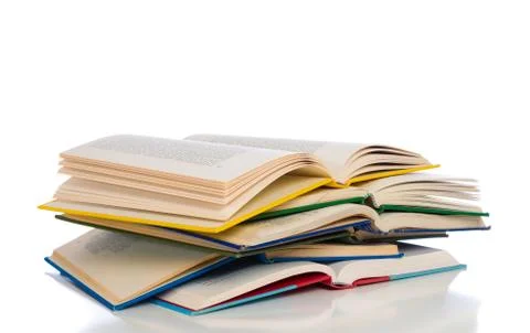 A stack of colorful, open books on a white background Stock Photos