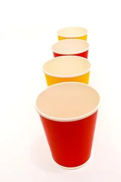 Stack of Colorful Paper Cups Arranged in a Row on White Background - Simple.. Stock Photos