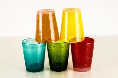 A stack of colorful plastic cups with glitter on them 库存照片