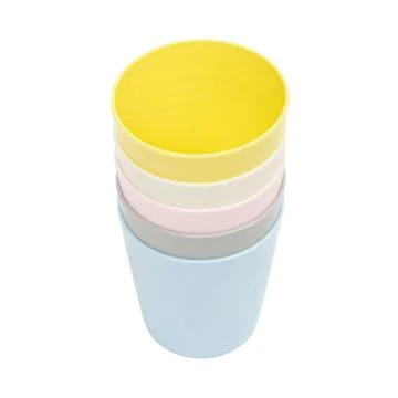 Stack of colorful plastic cups on white background. Pastel drinking contain.. Stock Photos