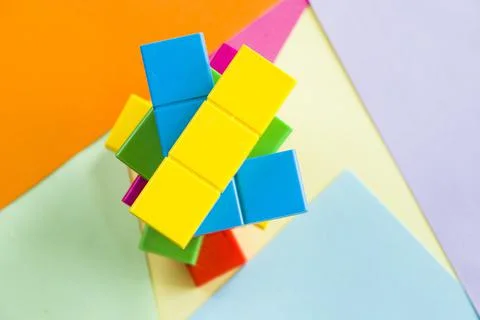 Stack of colorful puzzle cubes in the multi-colored background Stockfoto's