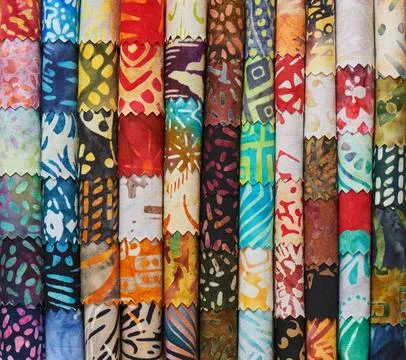 Stack of colorful quilting batik fabrics as a vibrant background image Stock-Fotos