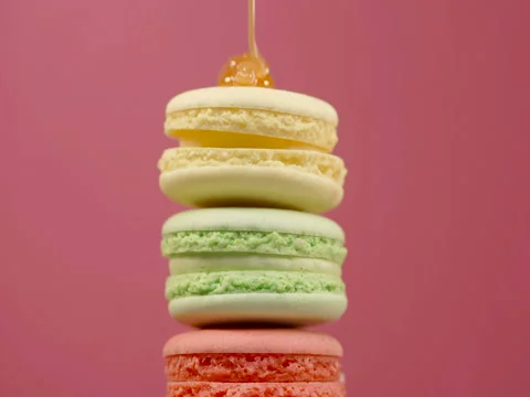 Stack of colorful rotating macaroons on color background Stock Footage 82904127