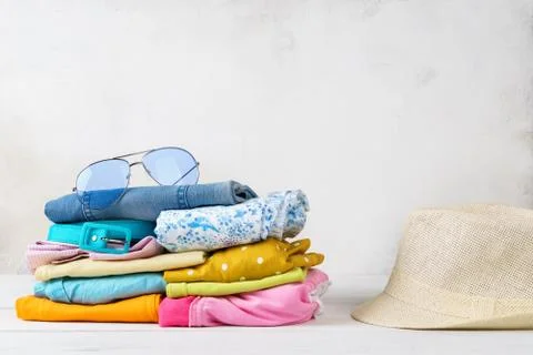 Stack of colorful summer clothes and accessories. Stock Photos
