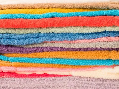 Stack of colorful terry towels folded. Shop Home. Numerous towels stacked and Foto stock