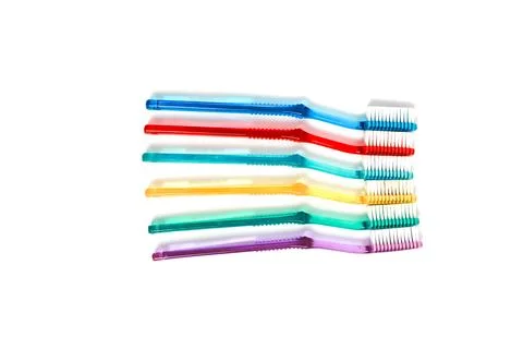 Stack of colorful toothbrushes on a white background highlighting oral hygi.. Stock Photos