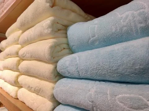 Stack of colorful towels on a shelf Stock Photos