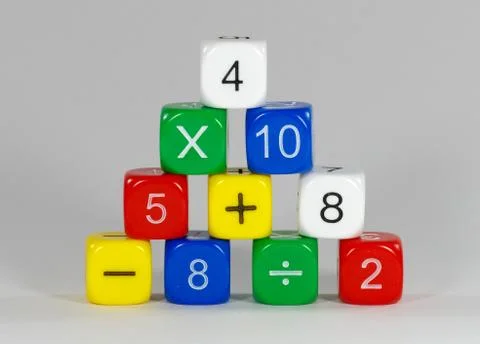 Stack of coloured dice with numbers and math signs Stock Photos