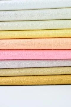 Stack of colourful cotton clothes, pile of clothing on white background 스톡 사진