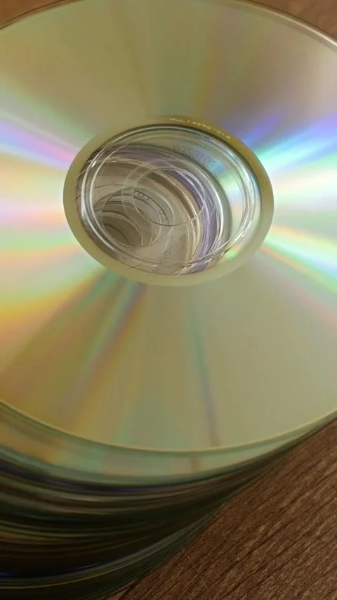 Stack of Compact Discs Reflecting Rainbow Light Stock Footage 341525110